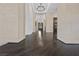 Stunning hallway with gleaming hardwood floors, stone columns, and elegant lighting at 9 Greely Club Trl, Henderson, NV 89052