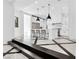 Modern kitchen with marble floors, white cabinets, and stainless steel appliances at 9 Greely Club Trl, Henderson, NV 89052