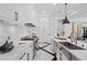 Spacious gourmet kitchen with white cabinetry, marble countertops, stainless steel appliances, and designer flooring at 9 Greely Club Trl, Henderson, NV 89052