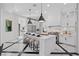 Gourmet kitchen featuring a large center island, custom cabinets, and sleek black and white design at 9 Greely Club Trl, Henderson, NV 89052
