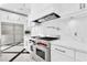 Modern kitchen featuring stainless steel appliances, white cabinets, and marble countertops at 9 Greely Club Trl, Henderson, NV 89052