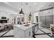 Spacious kitchen with marble countertops, island seating, and stainless steel appliances at 9 Greely Club Trl, Henderson, NV 89052