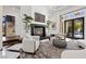 Inviting living room with a cozy fireplace, stylish seating, and seamless indoor-outdoor flow at 9 Greely Club Trl, Henderson, NV 89052