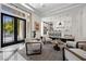 Bright living space features sleek modern furniture and an open layout to the kitchen at 9 Greely Club Trl, Henderson, NV 89052