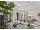 Bright living room with high ceilings, modern furniture, and an open view to the kitchen at 9 Greely Club Trl, Henderson, NV 89052