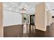 Spacious living room with dark wood floors, modern chandelier, and large windows at 9 Greely Club Trl, Henderson, NV 89052