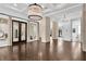 Bright living room with chandelier, columns, and hardwood floors at 9 Greely Club Trl, Henderson, NV 89052