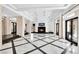 Bright living room features a fireplace, high ceilings, and designer tile flooring at 9 Greely Club Trl, Henderson, NV 89052