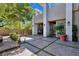 Courtyard features tiled patio, lush plants, and outdoor seating at 9 Greely Club Trl, Henderson, NV 89052