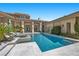 Inviting pool with clean tile and stone accents complements the modern architectural design of the home at 9 Greely Club Trl, Henderson, NV 89052