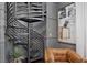 Close up view of modern metal spiral staircase next to a leather chair at 9 Greely Club Trl, Henderson, NV 89052