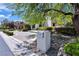 Beautiful home with a stone mailbox set amidst mature trees and lush landscaping at 9 Greely Club Trl, Henderson, NV 89052