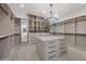 Spacious walk-in closet with custom shelving and an island for organization at 9 Greely Club Trl, Henderson, NV 89052