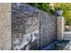 Outdoor water feature with stone wall, providing a tranquil and visually appealing addition to the backyard landscape at 9 Greely Club Trl, Henderson, NV 89052