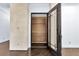 Entryway to wine cellar with dark wood floors and custom shelving at 9 Greely Club Trl, Henderson, NV 89052
