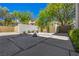 Outdoor Zen garden features desert landscaping design with stone water feature and small trees at 9 Greely Club Trl, Henderson, NV 89052
