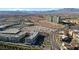 This aerial shows modern apartment buildings near commercial and greenspace in the desert landscape at 9173 Whitekirk Pl, Las Vegas, NV 89145