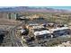 This aerial shot shows the residences near commercial areas, parking and golf course at 9173 Whitekirk Pl, Las Vegas, NV 89145