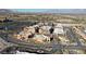 An aerial view showcases the Mediterranean-style architecture near the golf course and desert landscape at 9173 Whitekirk Pl, Las Vegas, NV 89145