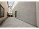Long backyard patio with slider door access and views down the side of the home at 9173 Whitekirk Pl, Las Vegas, NV 89145