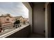 Balcony view shows surrounding houses, blue sky and railing at 9173 Whitekirk Pl, Las Vegas, NV 89145