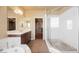 Spacious bathroom with a soaking tub, glass shower, and double vanity offers a spa-like retreat in your home at 9173 Whitekirk Pl, Las Vegas, NV 89145