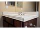 Bathroom vanity with white countertops and dark wood cabinets at 9173 Whitekirk Pl, Las Vegas, NV 89145