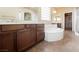 Bathroom showcasing double vanity sinks, large tub, and a spacious walk-in closet at 9173 Whitekirk Pl, Las Vegas, NV 89145