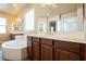 Bathroom featuring a large tub with a double sink vanity and a glass block window at 9173 Whitekirk Pl, Las Vegas, NV 89145