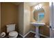 Powder room with pedestal sink, oval mirror, and tile flooring, offering a functional and stylish space at 9173 Whitekirk Pl, Las Vegas, NV 89145