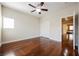 Bedroom with hardwood floors, ceiling fan, closet, and a large doorway at 9173 Whitekirk Pl, Las Vegas, NV 89145