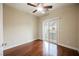 Cozy bedroom with wood floors, ceiling fan, and sliding doors to the outside at 9173 Whitekirk Pl, Las Vegas, NV 89145
