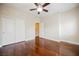 Bright bedroom featuring hardwood floors, ceiling fan, and closet at 9173 Whitekirk Pl, Las Vegas, NV 89145