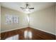 Bedroom with wood floors, ceiling fan, and natural light at 9173 Whitekirk Pl, Las Vegas, NV 89145