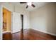 Bedroom with hardwood floors, closet, and access to the staircase and hallway at 9173 Whitekirk Pl, Las Vegas, NV 89145