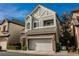 Charming two-story home featuring stone accents, a two-car garage, and manicured landscaping at 9173 Whitekirk Pl, Las Vegas, NV 89145