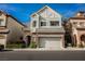 Charming two-story home featuring stone accents, a two-car garage, and manicured landscaping at 9173 Whitekirk Pl, Las Vegas, NV 89145