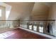 Upstairs hallway with decorative wrought iron railing and views into the main living area below at 9173 Whitekirk Pl, Las Vegas, NV 89145