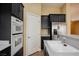 Bright kitchen featuring modern appliances, a built-in oven, and convenient access to the pantry at 9173 Whitekirk Pl, Las Vegas, NV 89145