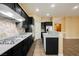 Well-equipped kitchen with dark cabinets, a gas cooktop, and tile backsplash, perfect for culinary adventures at 9173 Whitekirk Pl, Las Vegas, NV 89145