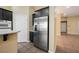 Kitchen with dark cabinets, stainless steel refrigerator and gas cooktop at 9173 Whitekirk Pl, Las Vegas, NV 89145