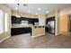 Modern kitchen featuring dark cabinets, stainless steel appliances, tile backsplash and eat-in counter at 9173 Whitekirk Pl, Las Vegas, NV 89145