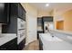 Kitchen with dark cabinets, stainless appliances, and a built-in oven at 9173 Whitekirk Pl, Las Vegas, NV 89145