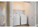 Convenient laundry room with washer and dryer hookups and storage shelves at 9173 Whitekirk Pl, Las Vegas, NV 89145