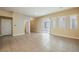 Bright and airy living room showcasing tile floors, neutral paint, and a sliding glass door at 9173 Whitekirk Pl, Las Vegas, NV 89145