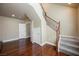 Open-concept living area with hardwood floors, staircase, and multiple doorways for seamless flow throughout the home at 9173 Whitekirk Pl, Las Vegas, NV 89145