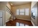 Inviting living area with hardwood floors, fireplace and staircase access at 9173 Whitekirk Pl, Las Vegas, NV 89145