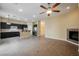 Open floor plan with fireplace seamlessly connects living space with the kitchen at 9173 Whitekirk Pl, Las Vegas, NV 89145