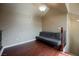 Upstairs loft with a gray futon and hardwood floors at 9173 Whitekirk Pl, Las Vegas, NV 89145