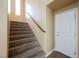 Carpeted staircase with wood railing leading to the upper level of the home at 9173 Whitekirk Pl, Las Vegas, NV 89145